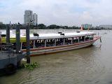 A Chao Phraya river express boat at a pier