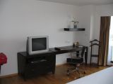 The TV and desk in the bedroom
